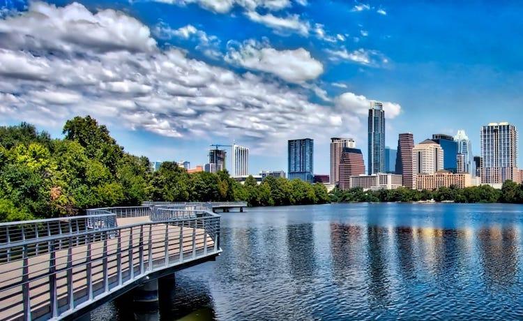 A photo of Lady Bird Lake and the city skyline in Austin, TX.